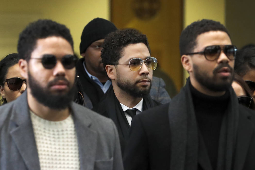 Actor Jussie Smollett, center, departs after an initial court appearance at the Leighton Crimin ...