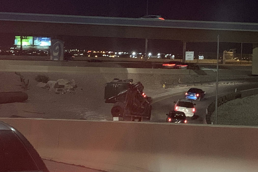 Police investigate a semitrailer rollover Monday, Feb. 24, 2020, on a ramp connecting U.S. High ...