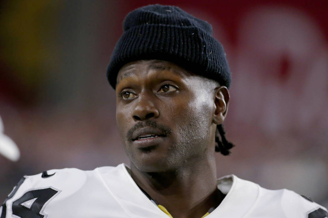 Former Oakland Raiders wide receiver Antonio Brown watches from the sidelines during the second ...