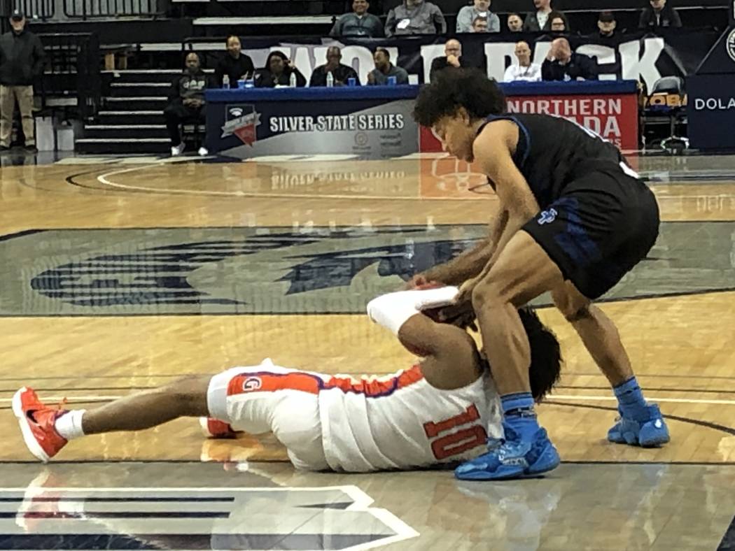 Desert Pines' Jamir Stephens ties up Bishop Gorman's Zaon Collins (10) in the Class 4A state bo ...