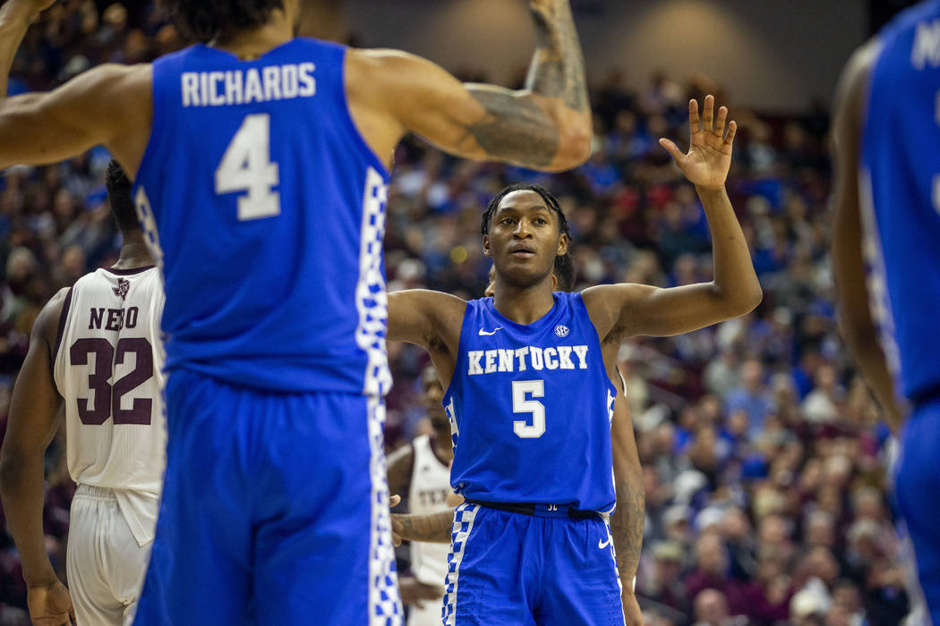 Kentucky guard Immanuel Quickley (5) reacts with teammate Nick Richards (4) after a foul call d ...