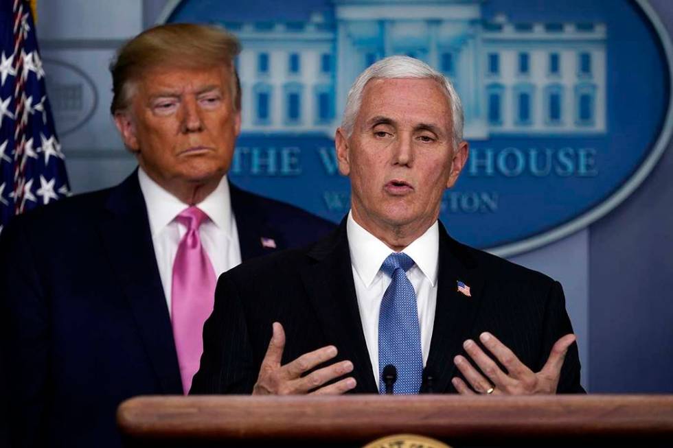 President Donald Trump listens as Vice President Mike Pence speaks during a news conference abo ...