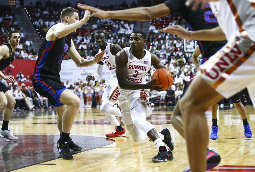 UNLV Rebels' Amauri Hardy (3) drives to the basket past Boise State Broncos' Riley Abercrombie ...