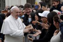 Pope Francis salutes faithful in St. Peter's Square at the Vatican before leaving after his wee ...