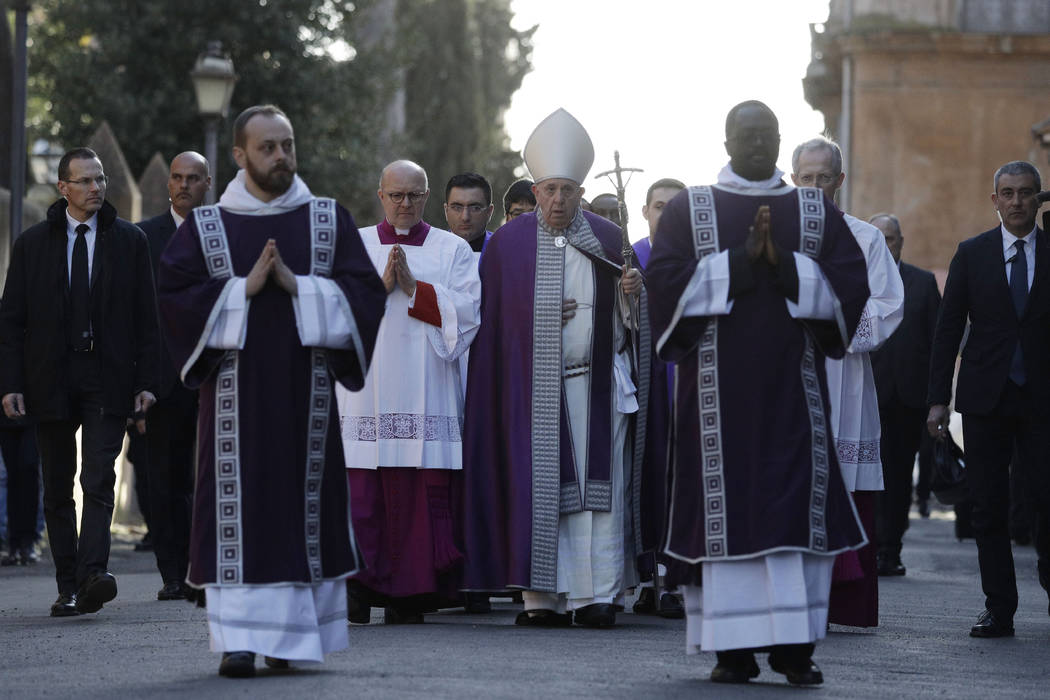 Pope Francis, center, walks in procession to the Basilica of Santa Sabina before the Ash Wednes ...