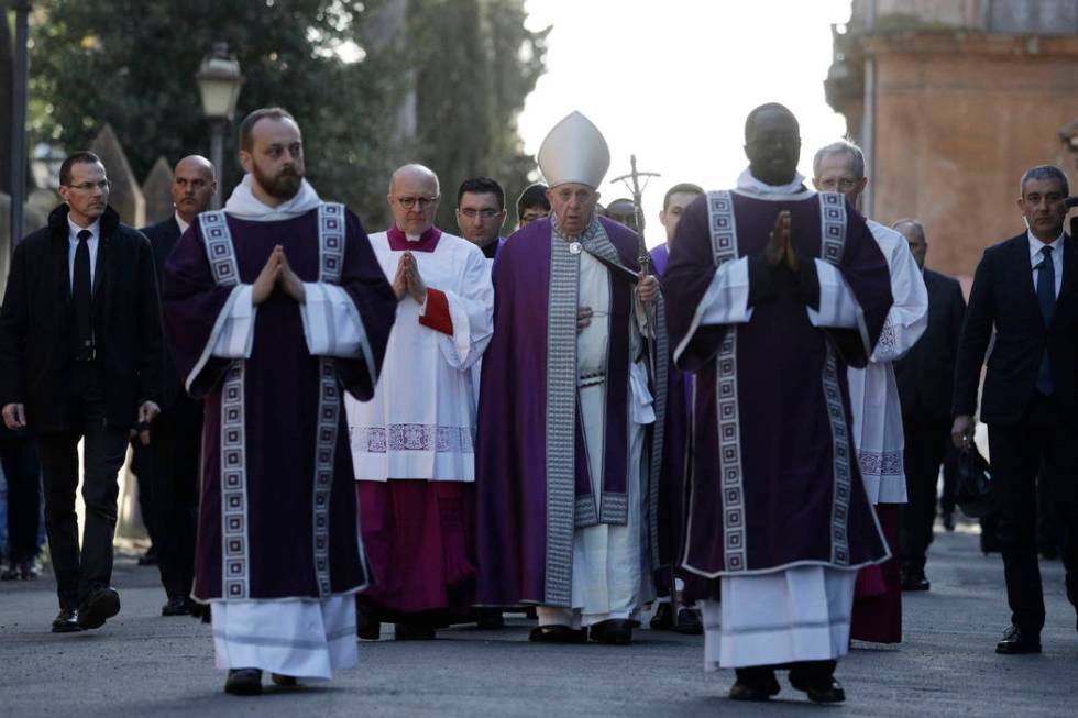 Pope Francis, center, walks in procession to the Basilica of Santa Sabina before the Ash Wednes ...