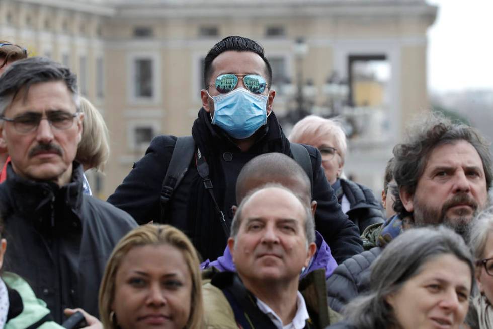 A man wears a face mask in St. Peter's Square at the Vatican during Pope Francis' weekly genera ...