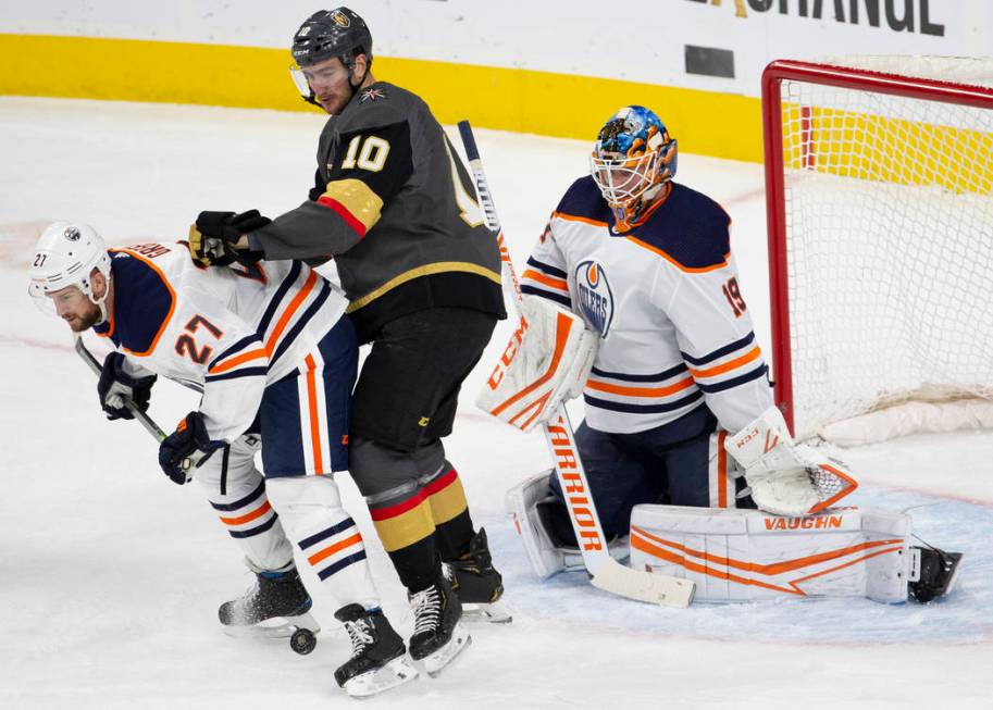 Edmonton Oilers defenseman Mike Green (27) blocks the shot of Vegas Golden Knights center Nicol ...