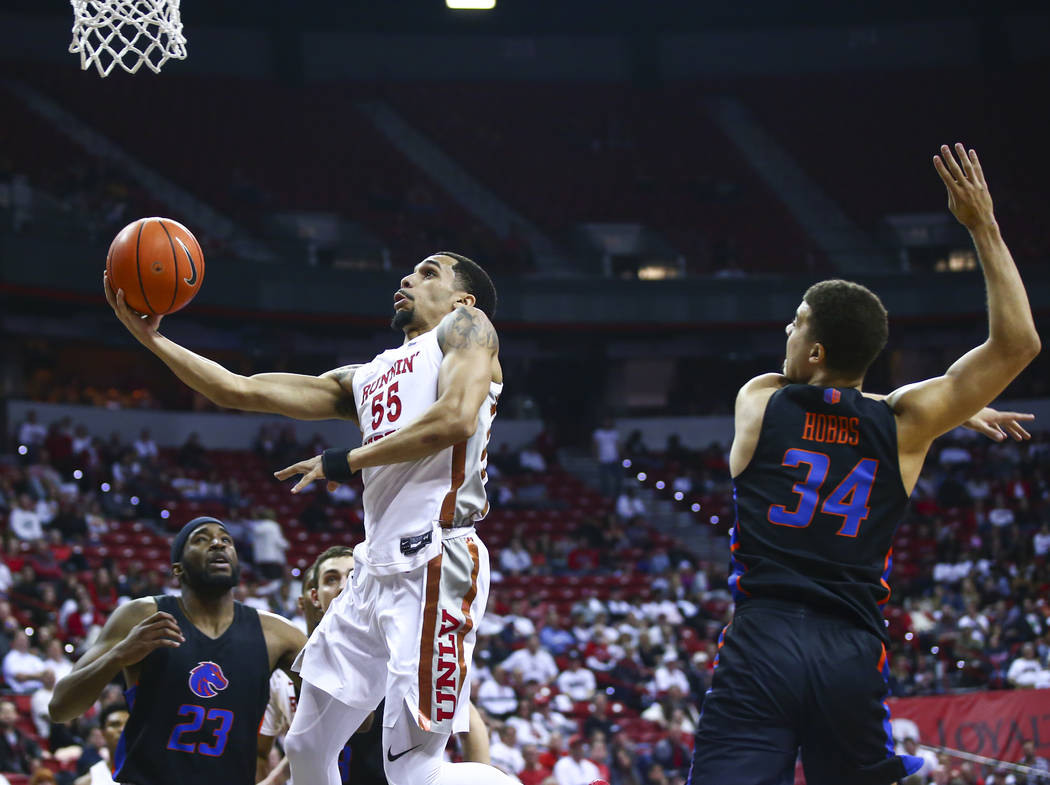 UNLV Rebels' Elijah Mitrou-Long (55) drives to the basket past Boise State Broncos' Alex Hobbs ...