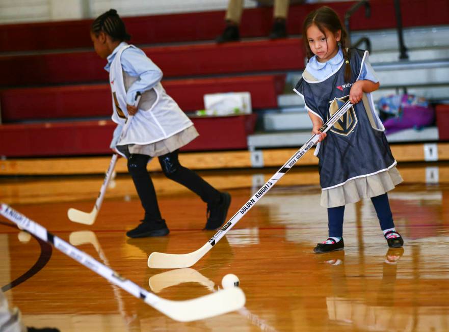 Five-year-old Penelope Henriquez-Ayala participates in a youth street hockey clinic at Doolittl ...