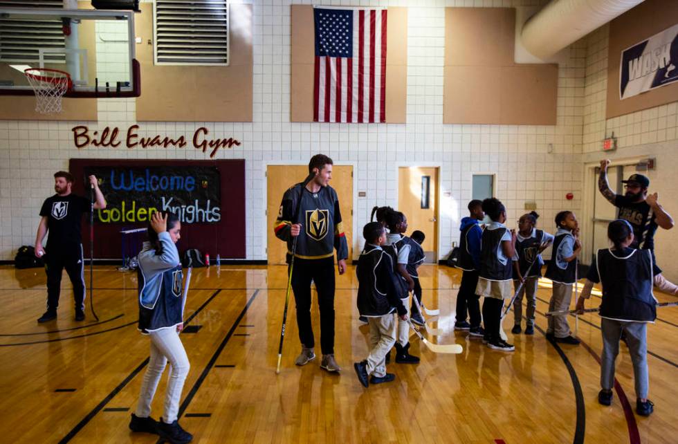 Golden Knights defenseman Brayden McNabb, center, helps lead a youth street hockey clinic at Do ...