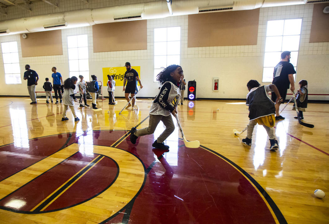 Nine-year-old Te'ric Williams chases after a ball during a youth street hockey clinic at Doolit ...