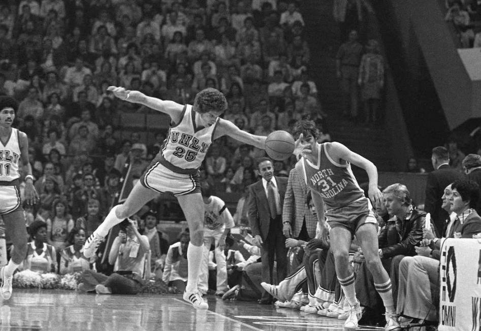 UNLV basketball player Glen Gondrezick (25), left, makes a long reach to save a ball headed out ...