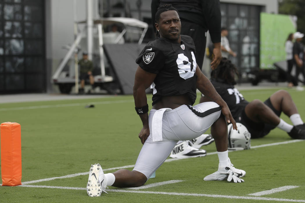 Oakland Raiders' Antonio Brown stretches during NFL football practice in Alameda, Calif., Tuesd ...