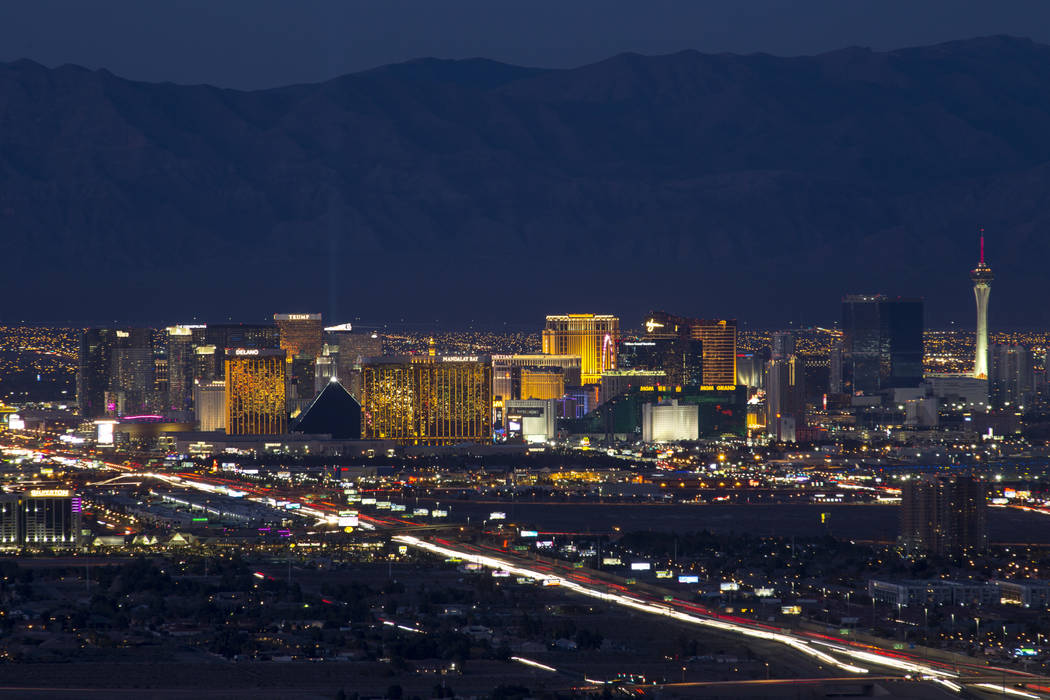 Traffic moves along Interstate 15 as Las Vegas casinos illuminate the city's skyline at dusk on ...