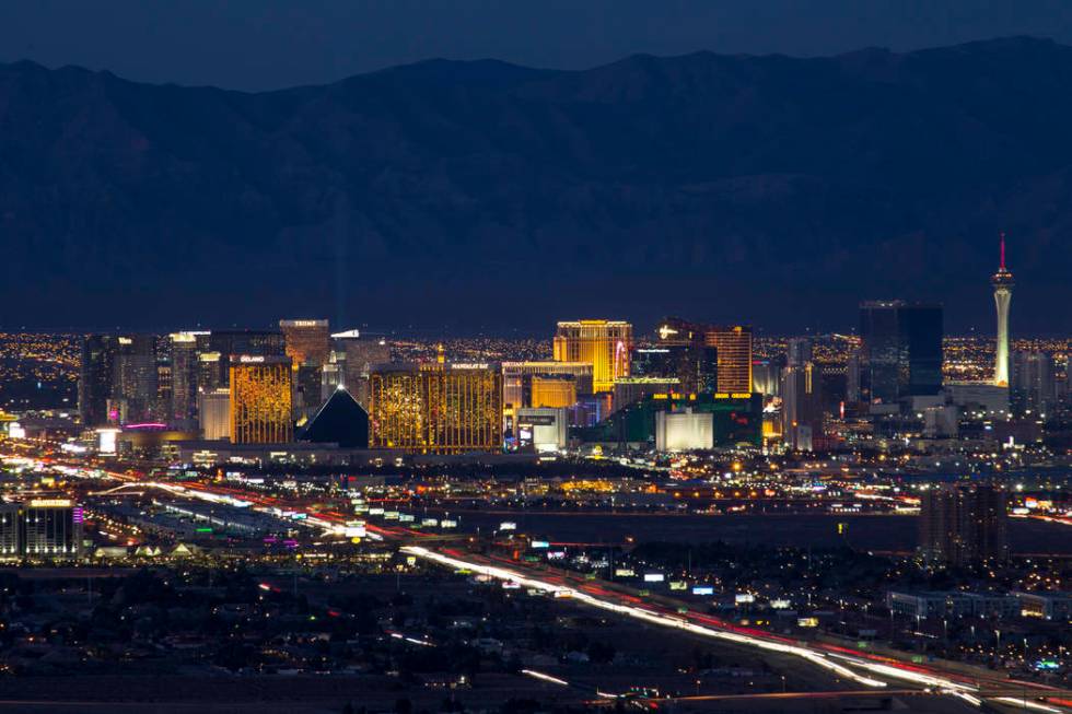 Traffic moves along Interstate 15 as Las Vegas casinos illuminate the city's skyline at dusk on ...