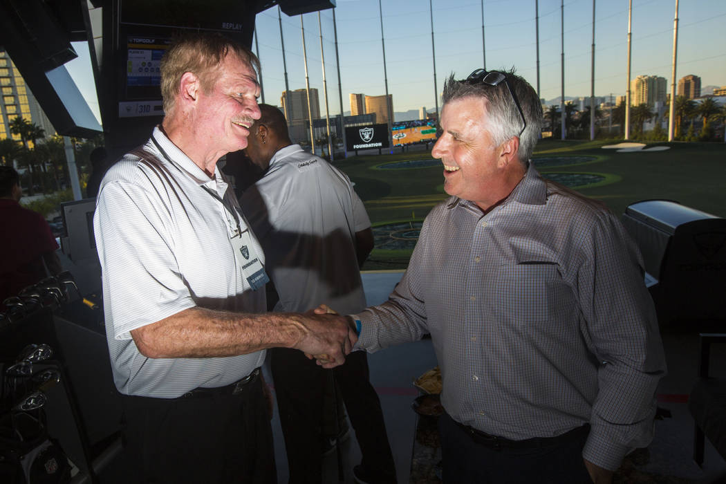 Former Oakland Raiders linebacker Ted Hendricks, left, mingles with attendees during the Raider ...