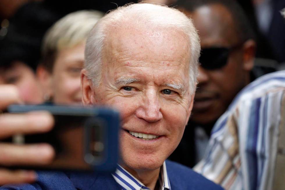 Democratic presidential candidate former Vice President Joe Biden takes a photo with supporters ...