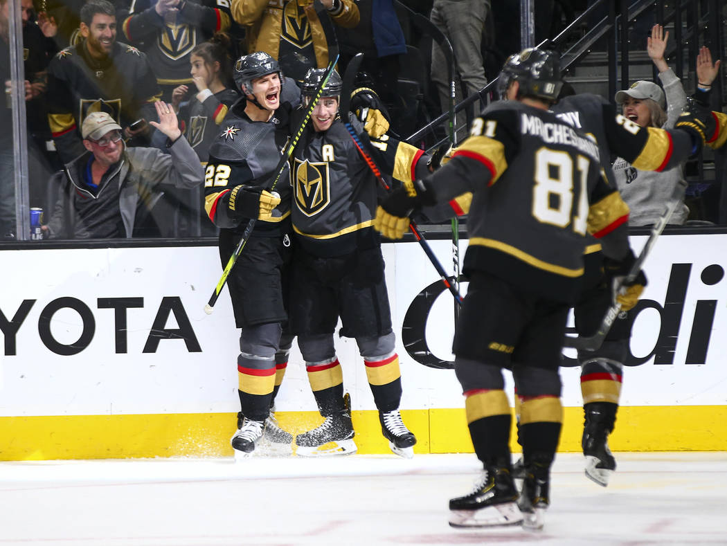 Golden Knights' Nick Holden (22) celebrates a goal by Reilly Smith during the third period of a ...