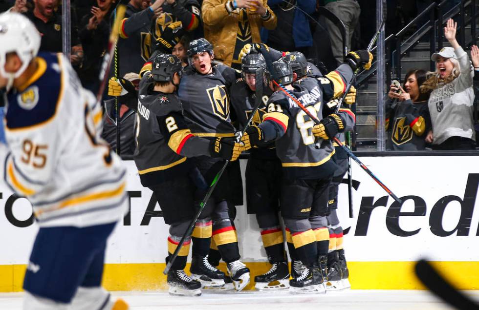 Golden Knights players celebrate a goal by Reilly Smith during the third period of an NHL hocke ...