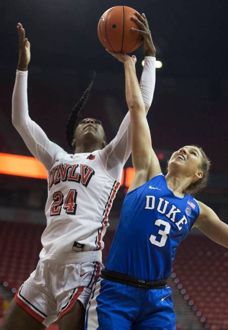 UNLV Lady Rebels guard Rodjanae Wade (24) fights for a rebound with Duke Blue Devils guard Miel ...