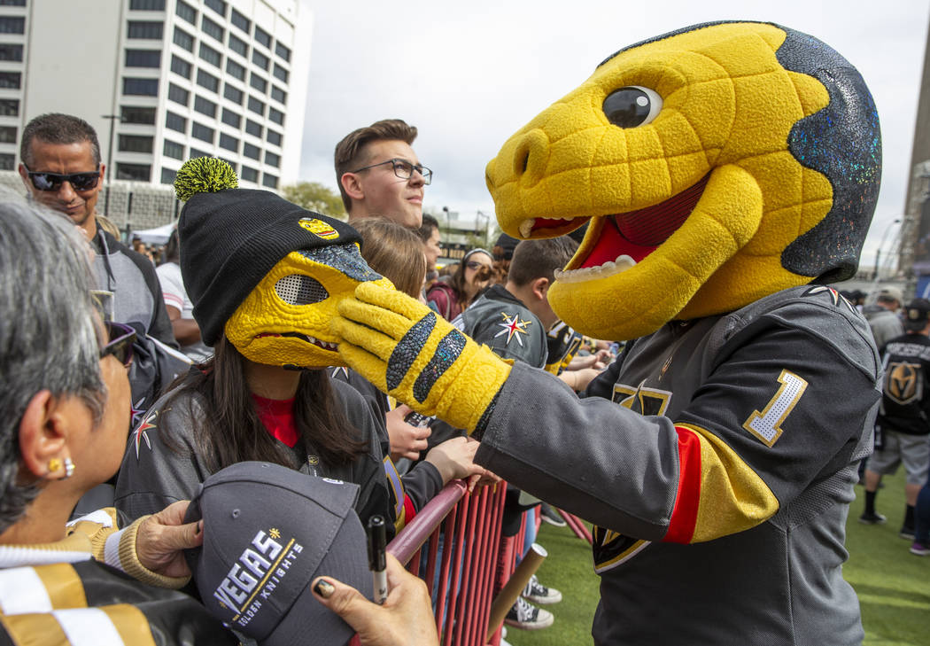 Chance the Gila Monster, right, reacts to fan Kylee Dupa, 11, being a smaller version of him du ...