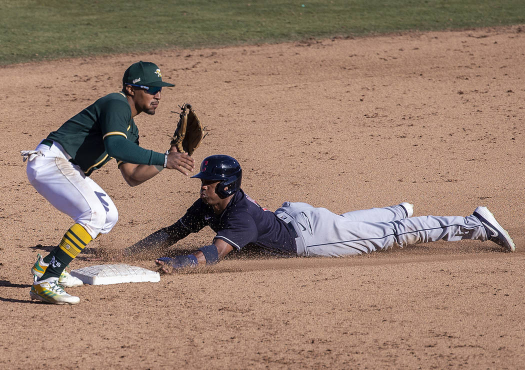 Cleveland Indians right fielder Greg Allen (1) slides safely under the tag of Oakland Athletics ...