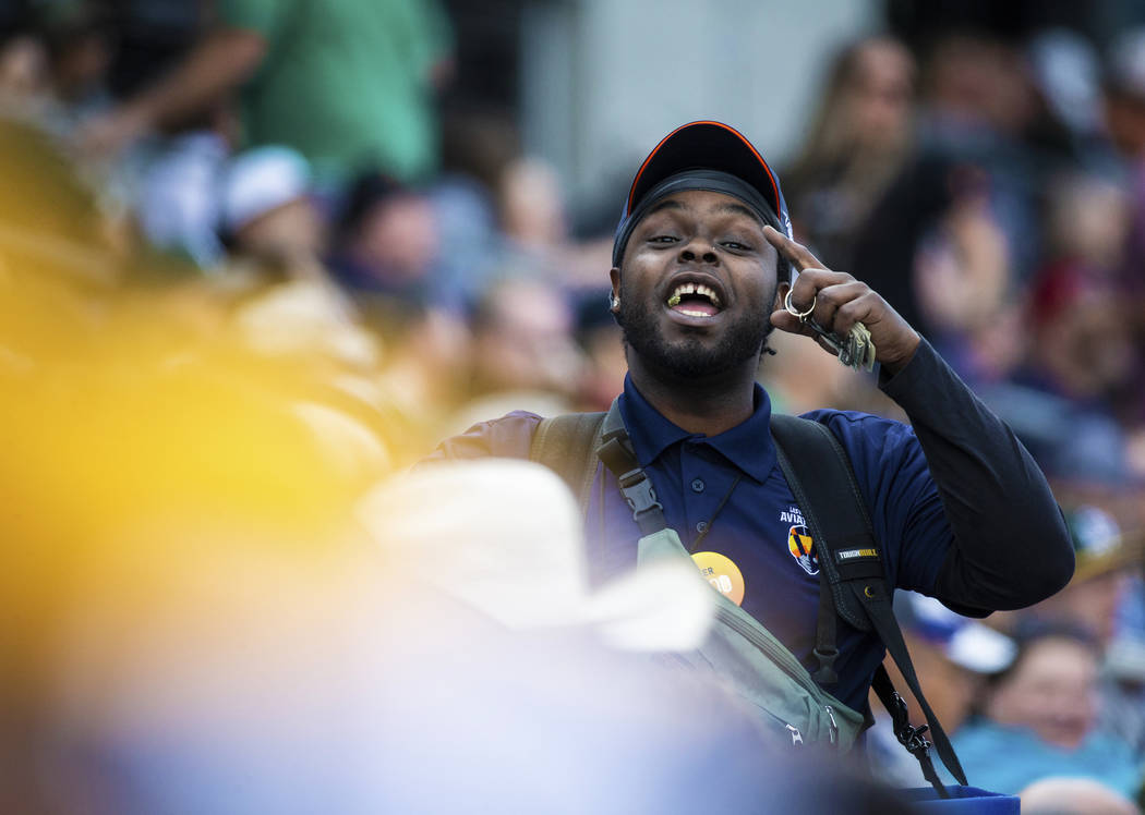 A beer vendor takes orders along the right field line in the third inning during a Major League ...