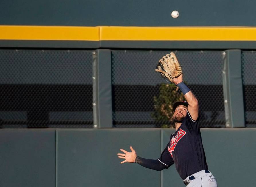 Cleveland Indians outfielder Ka'ai Tom (81) makes a leaping catch in the eighth inning during a ...