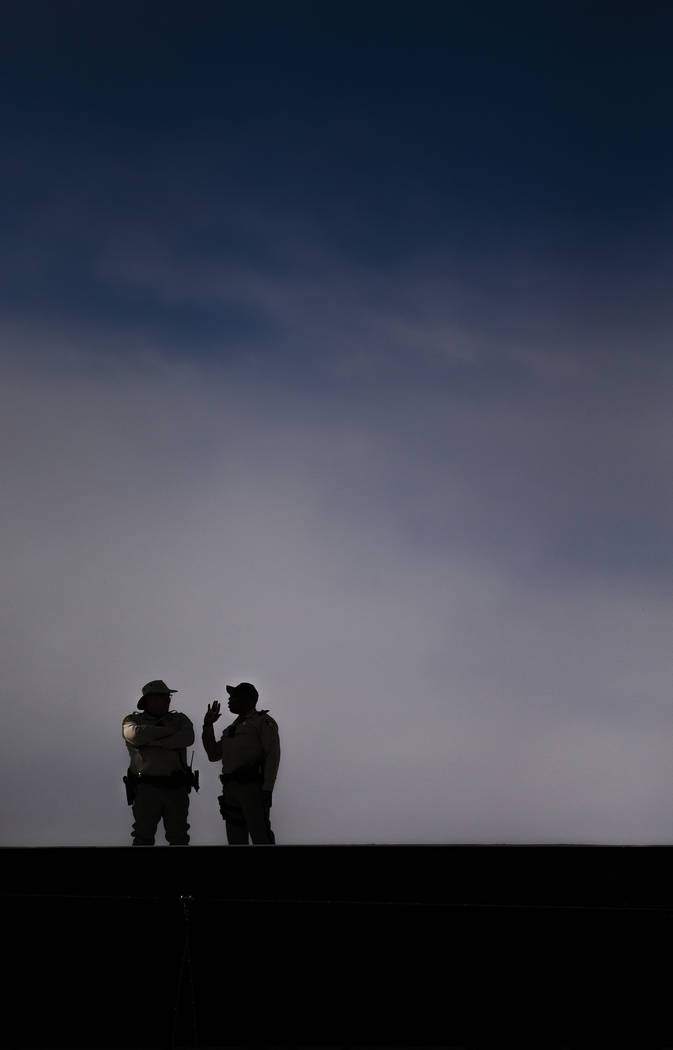 Security stands guard on top of Las Vegas Ballpark during a Major League Baseball game between ...