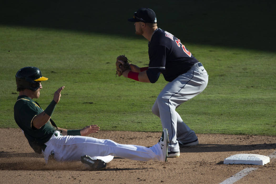 Oakland Athletics center fielder Skye Bolt (49) slides in safely past Cleveland Indians third b ...