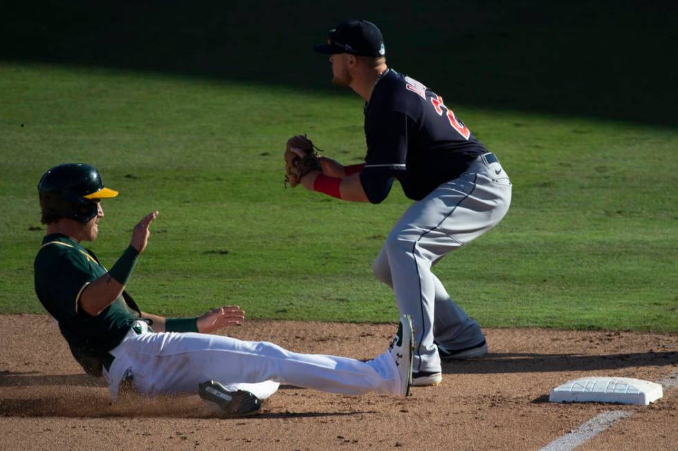 Oakland Athletics center fielder Skye Bolt (49) slides in safely past Cleveland Indians third b ...