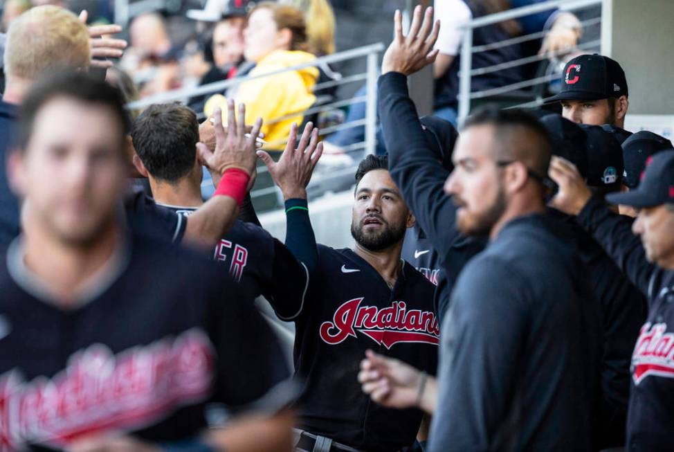 Cleveland Indians outfielder Ka'ai Tom, middle, celebrates with teammates after scoring in the ...