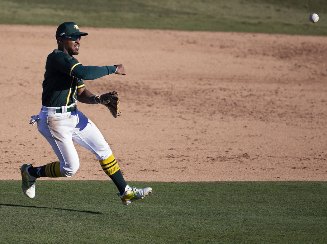 Oakland Athletics second baseman Tony Kemp (5) makes a leaping throw in the sixth inning during ...