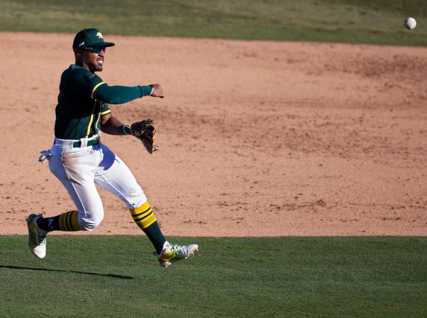 Oakland Athletics second baseman Tony Kemp (5) makes a leaping throw in the sixth inning during ...