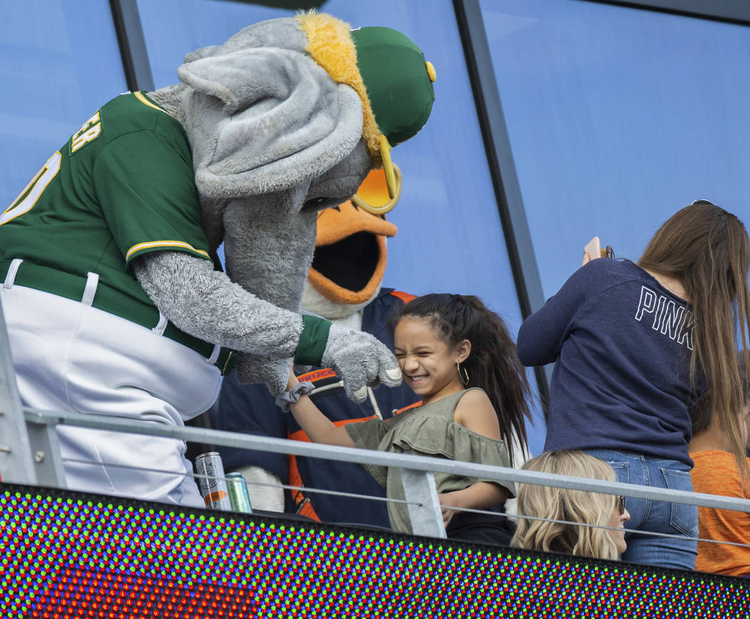 Oakland Athletics mascot "Stomper," left, entertains fans during a Major League Baseb ...