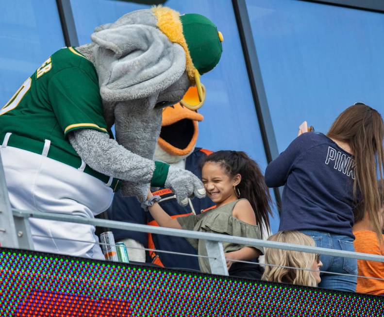 Oakland Athletics mascot "Stomper," left, entertains fans during a Major League Baseb ...