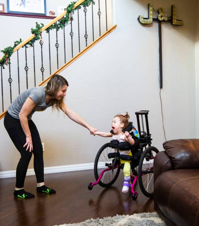 Ariana uses an adaptive “stander” that helps her bear weight on her legs. (Chase Stevens)