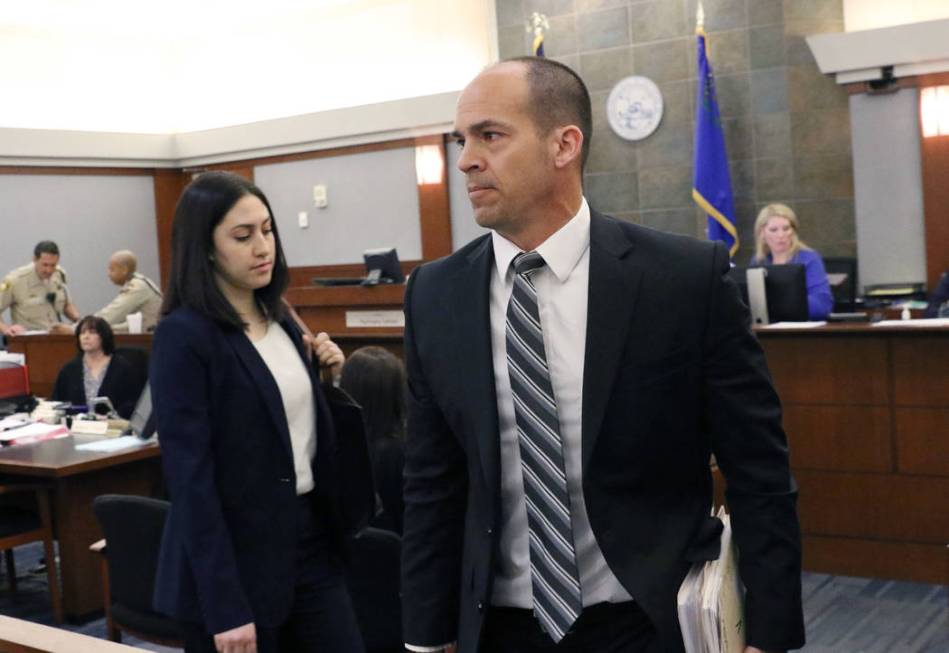 Chief Deputy District Attorney, Richard Scow, right, leaves the courtroom after a hearing at th ...