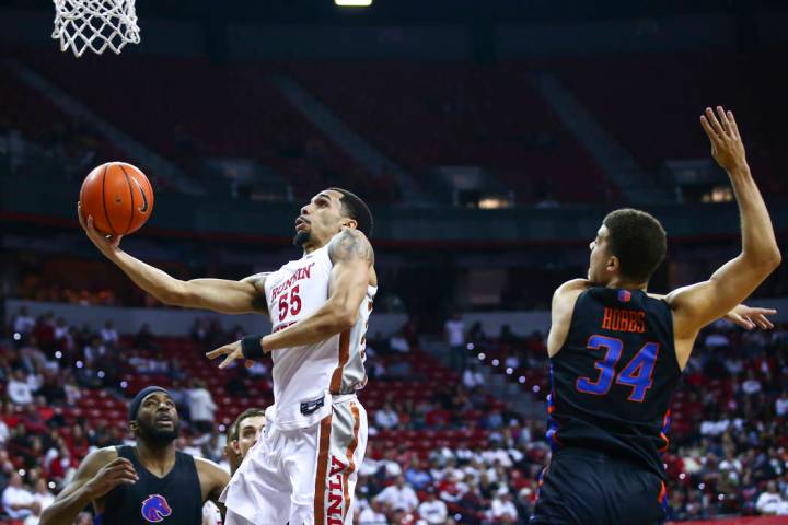 UNLV Rebels' Elijah Mitrou-Long (55) drives to the basket past Boise State Broncos' Alex Hobbs ...