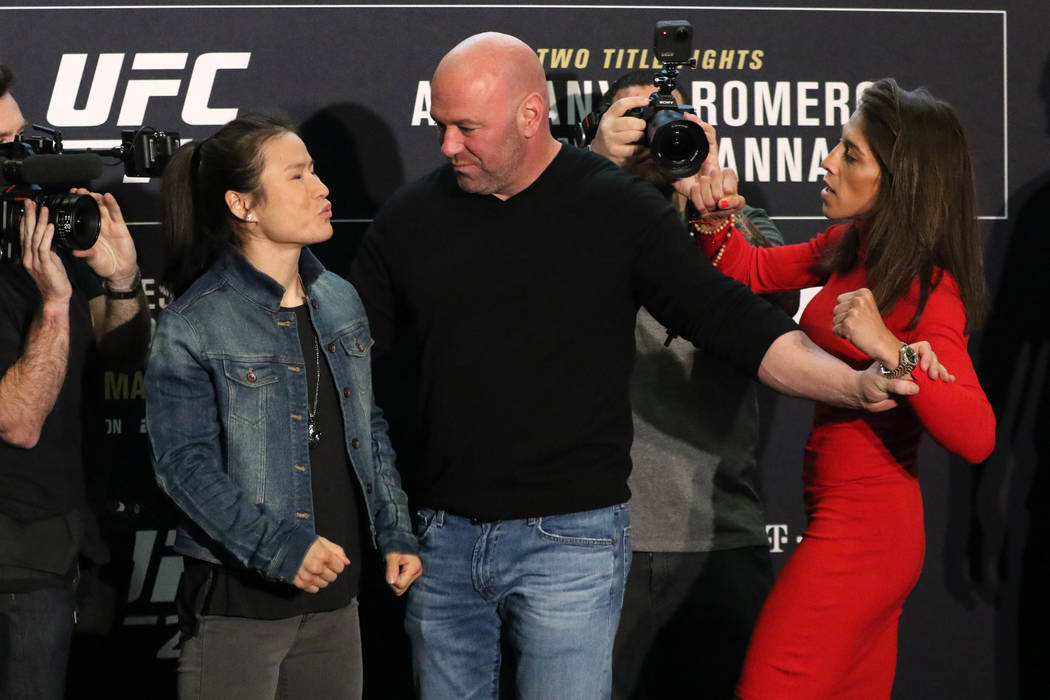 UFC strawweight champion Zhang Weili, left, blows a kiss to her opponent, Joanna Jedrzejczyk, r ...