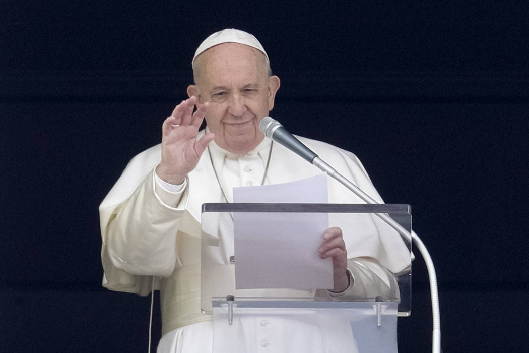 Pope Francis delivers his blessing during the Angelus noon prayer from the window of his studio ...