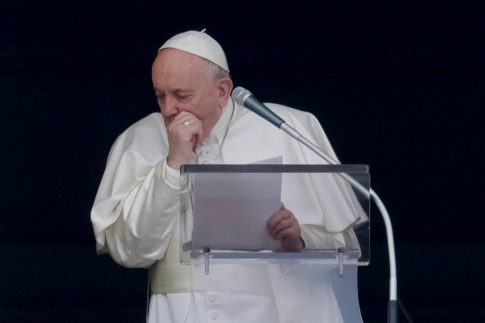 Pope Francis coughs during the Angelus noon prayer he recited from the window of his studio ove ...