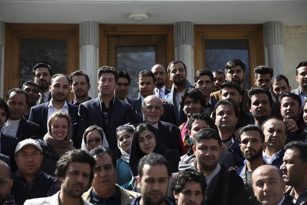 Afghan President Ashraf Ghani center, take a picture with journalists after a news conference a ...