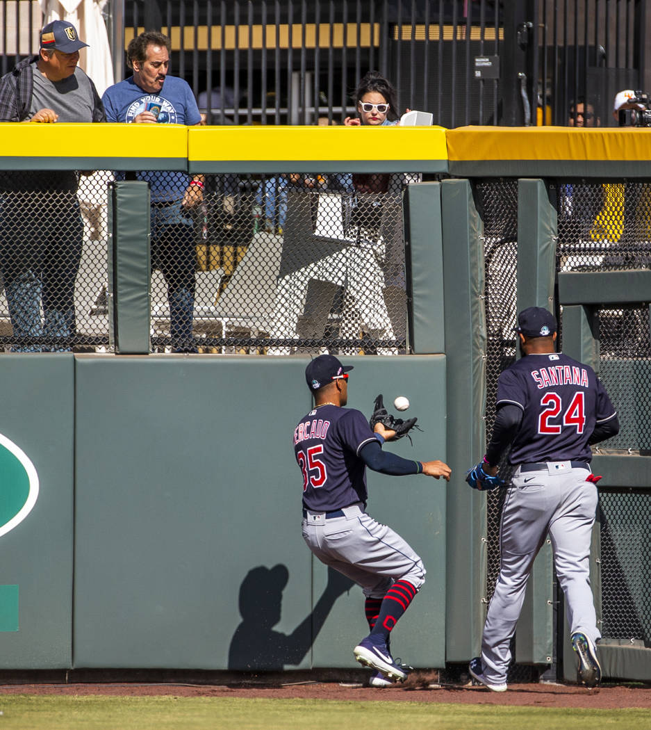 Cleveland Indians outfielder Oscar Mercado (35) attempts a catch off the wall beside teammate D ...