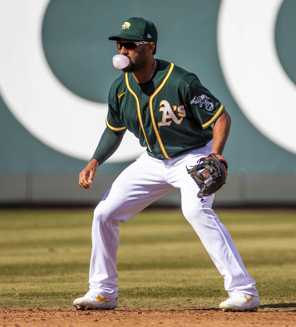 Oakland Athletics infielder Marcus Semien (10) blows a bubble while at shortstop versus the Cle ...