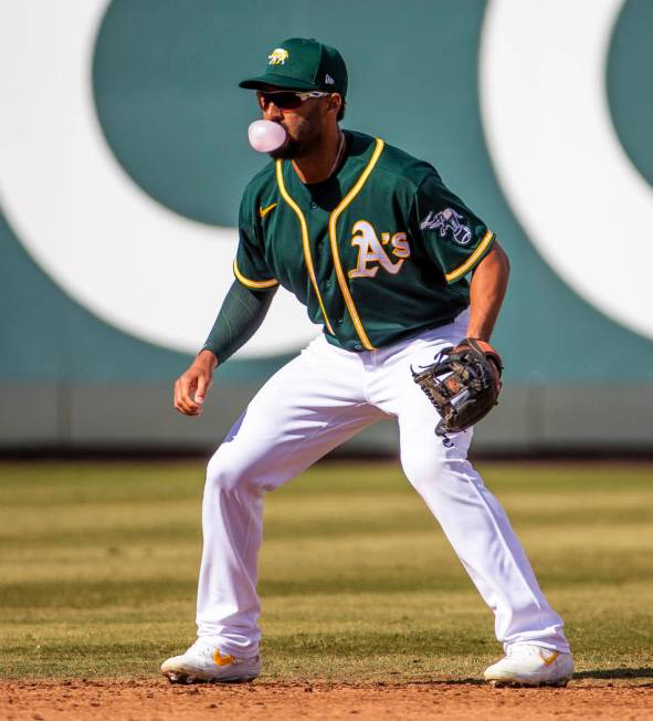 Oakland Athletics infielder Marcus Semien (10) blows a bubble while at shortstop versus the Cle ...