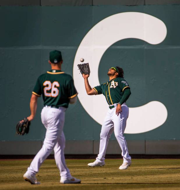 Oakland Athletics outfielder Dillon Thomas (71) looks in a long fly ball by the Cleveland India ...