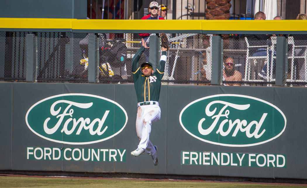 Oakland Athletics outfielder Ramon Laureano (22) makes a jumping catch over the Cleveland India ...