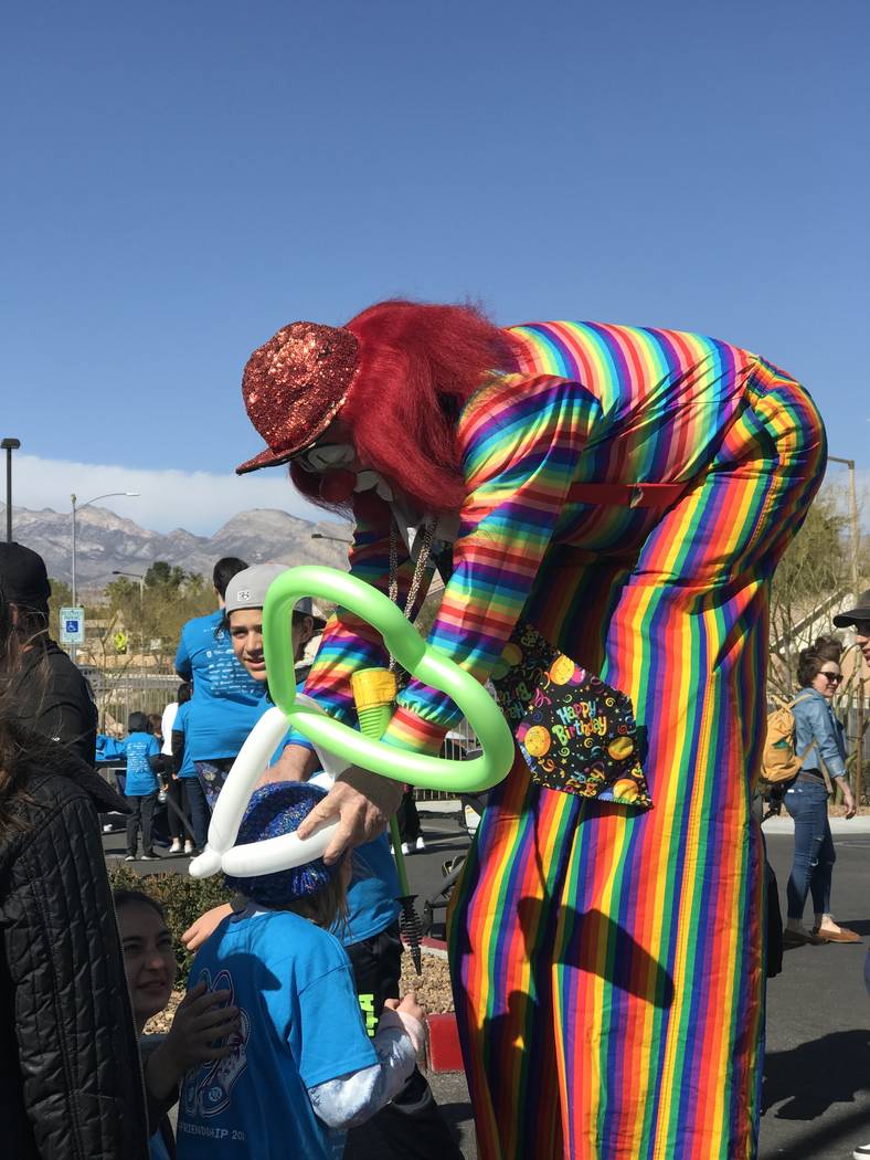Charlie the Clown makes balloon crowns for children during Walk4Friendship at Bet Yossef Commun ...